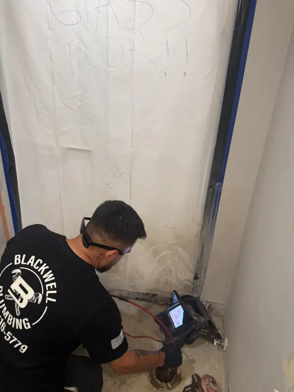 Blackwell Plumbing technician running a camera inspection at a floor drain